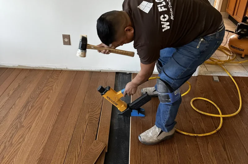 Wc Floors Worker installing hardwood floors WC Floors team performing hardwood floor installation in New Jersey
